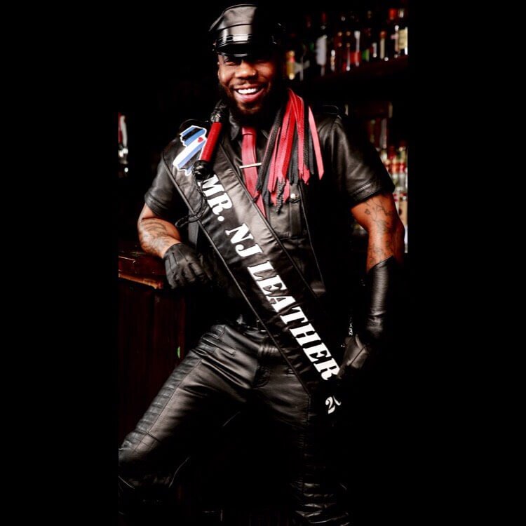 Full Image of Lynx, Mr. NJ Leather 2019 Dressed in black leather gear with a leather cap