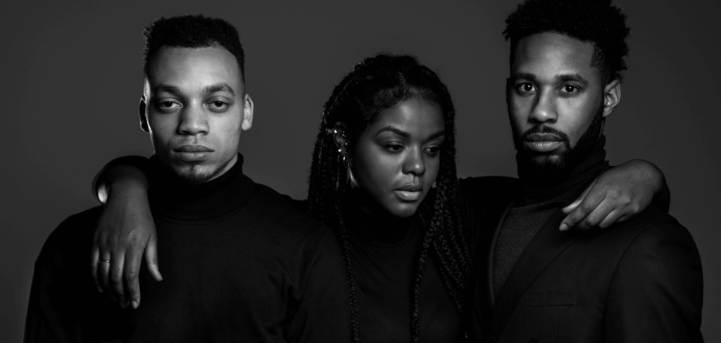 grayscale photo of an African-American Woman Standing in the Middle of Two African-American Men