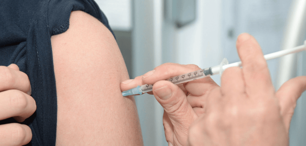 Man at the doctor's office getting his flu shot