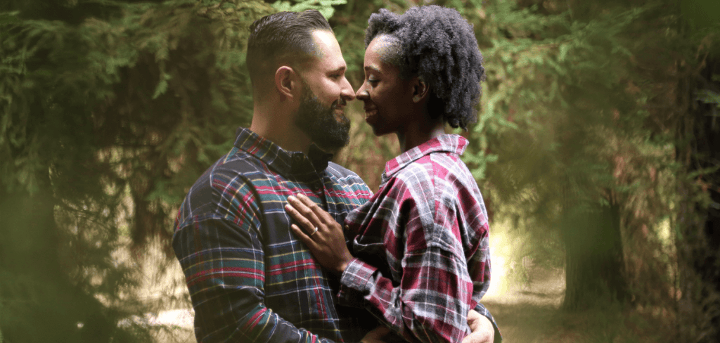 A caucasian man with an African-American Woman Wearing Button Shirts Smiling Face to Face Saying I Love You