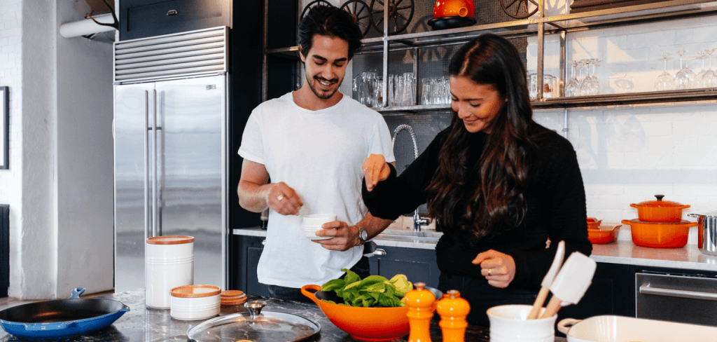 A white couple in a luxury kitchen preparing a healthy mea to beat depression