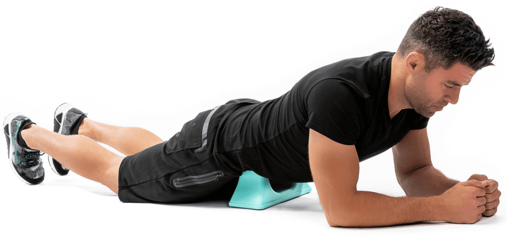 A man on the floor giving himself a self-massage using the PSO-RITE