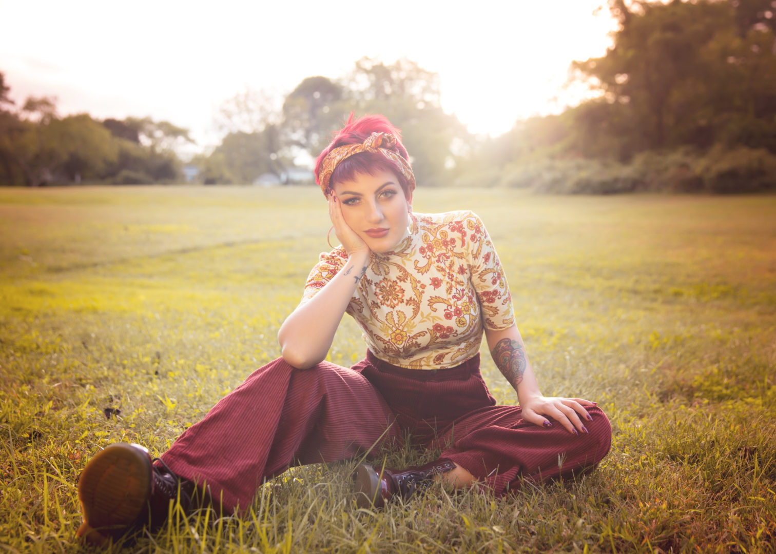 Photo of Singer Song Writer Tina DeCara seating on the grass