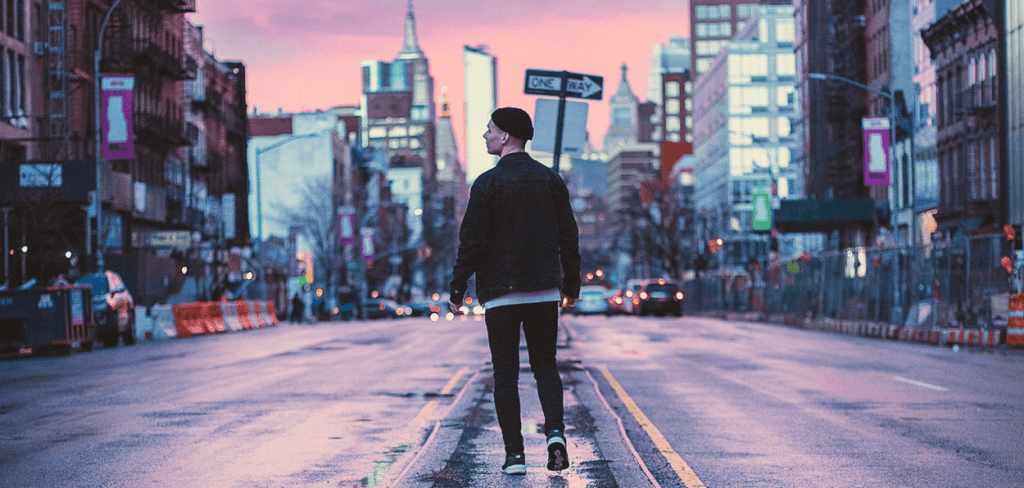 Young Man Walking in NYC Down the Middle of the Street