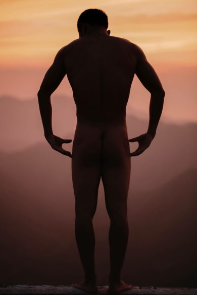 Sexual Man standing nude on the Great Wall in China while the sun was setting and the skies were burning.
