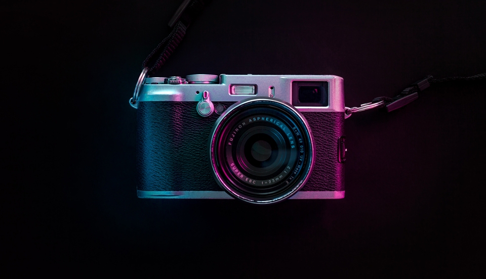 a photo of a vintage camera with purple lighting