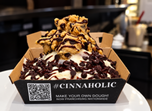 Cookie Monster cinnamon roll from Cinnaholic in Chelsea, topped with cookie dough, chocolate chips, and chocolate drizzle
