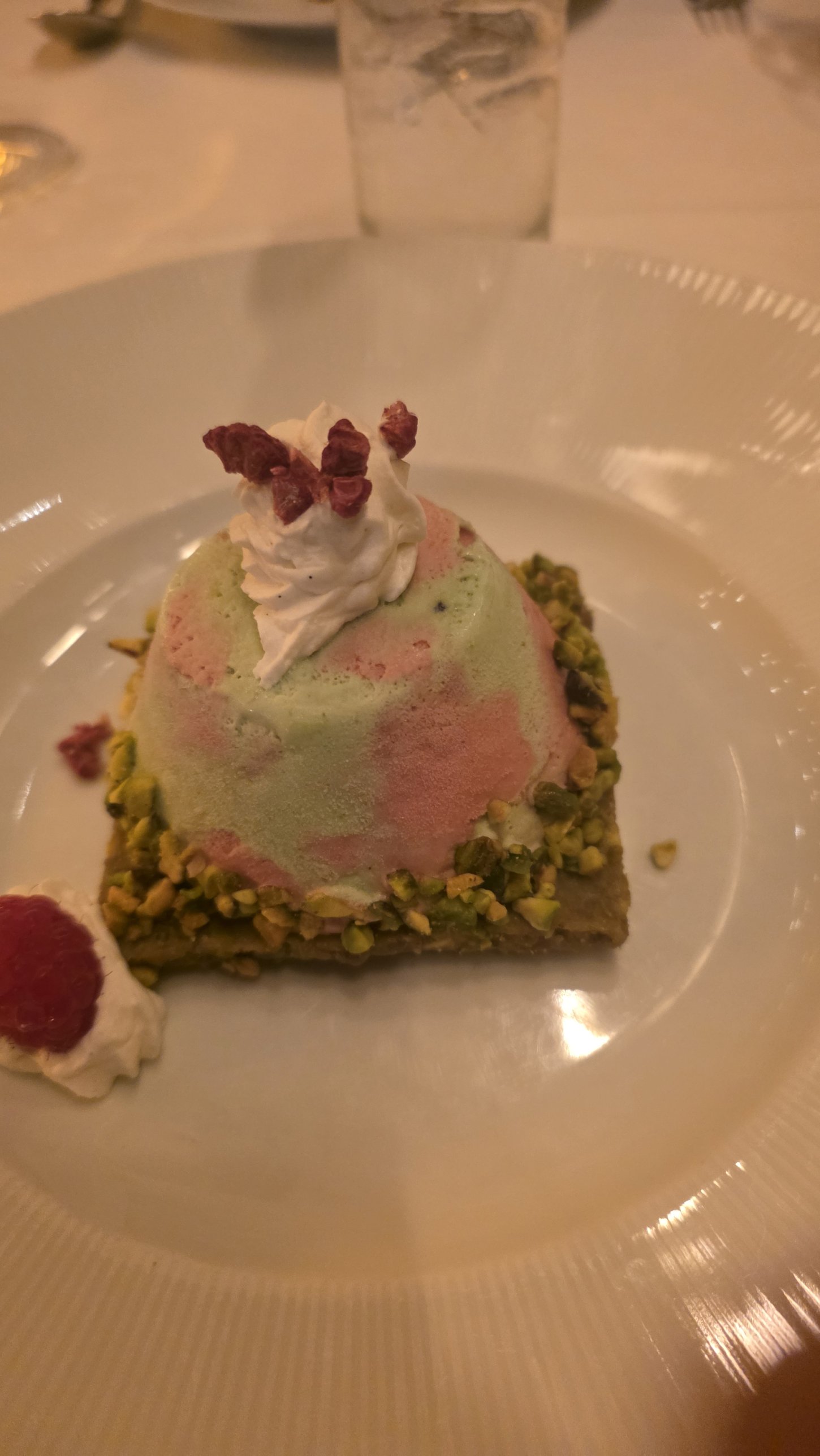 Raspberry and pistachio ice cream with whipped cream at The Grand Tier