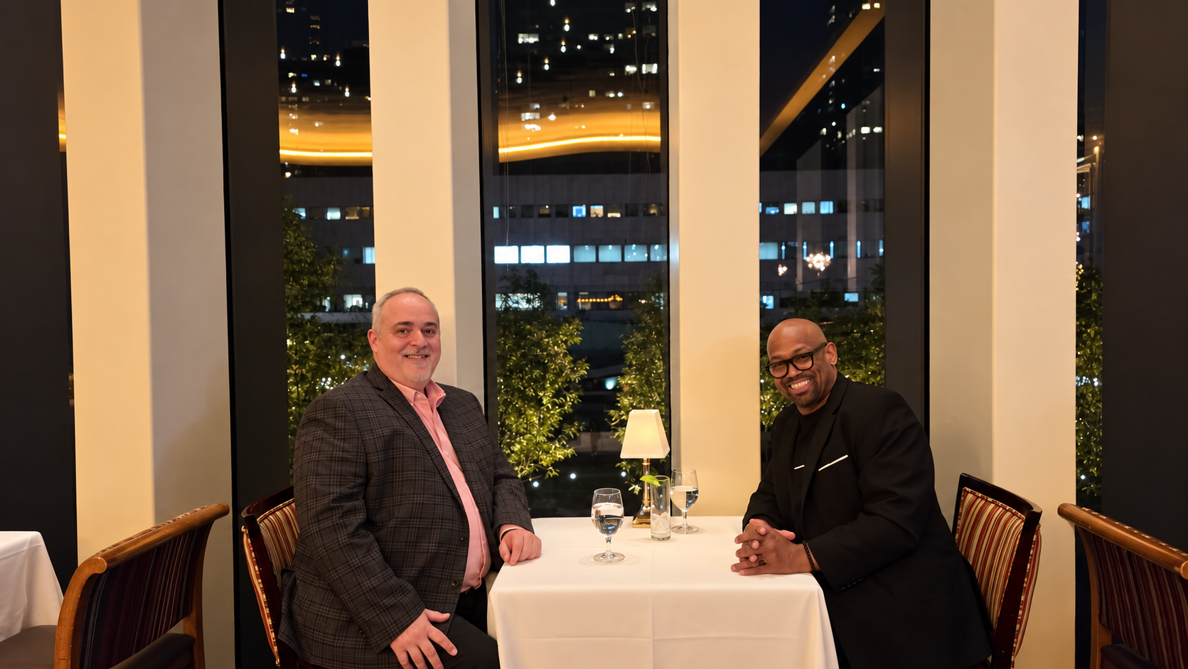 Corey Wesley and his best friend seated at a window table at The Grand Tier restaurant at Lincoln Center