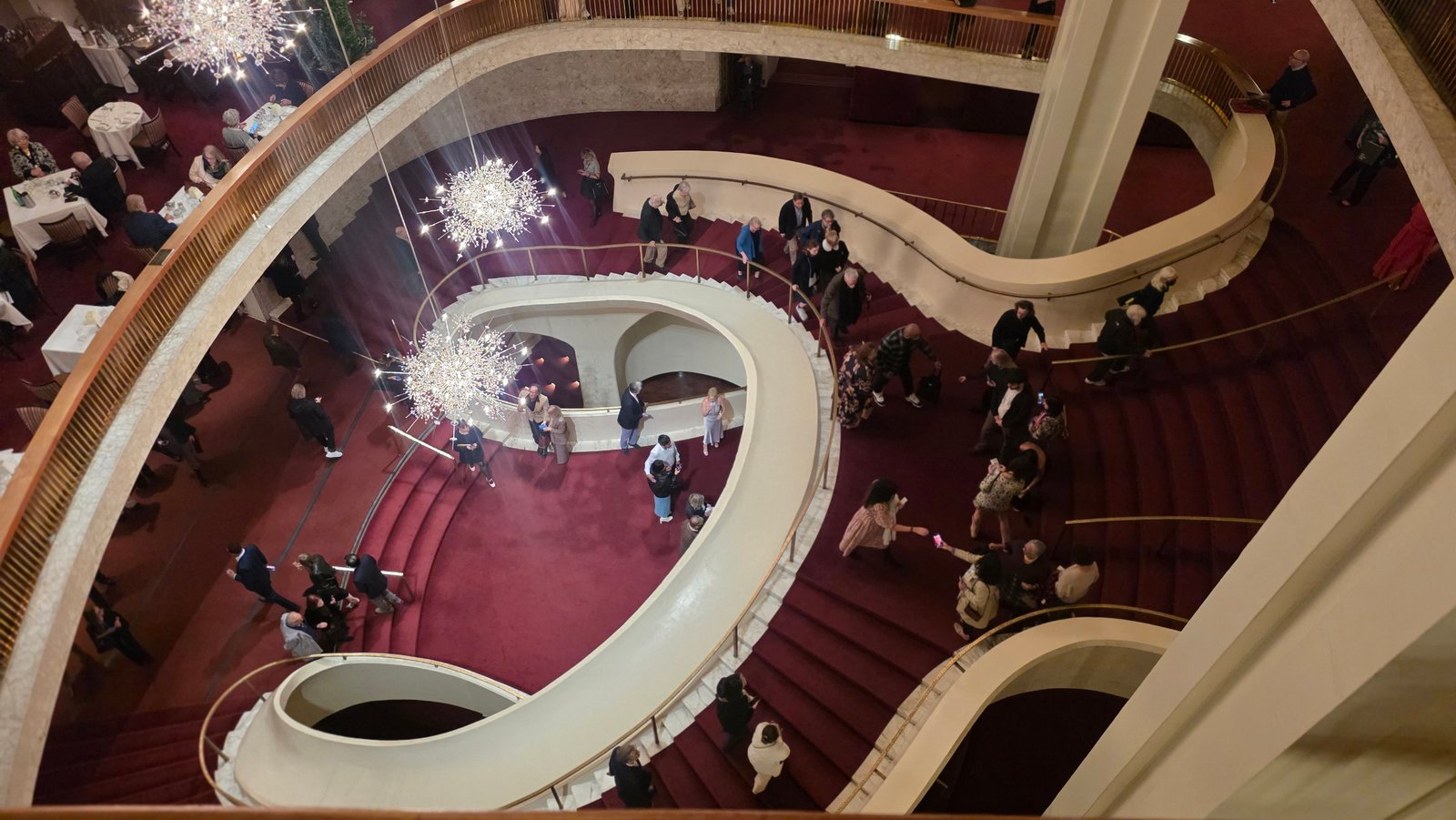 Looking down at the curved grand staircase and red carpet inside the Metropolitan Opera House