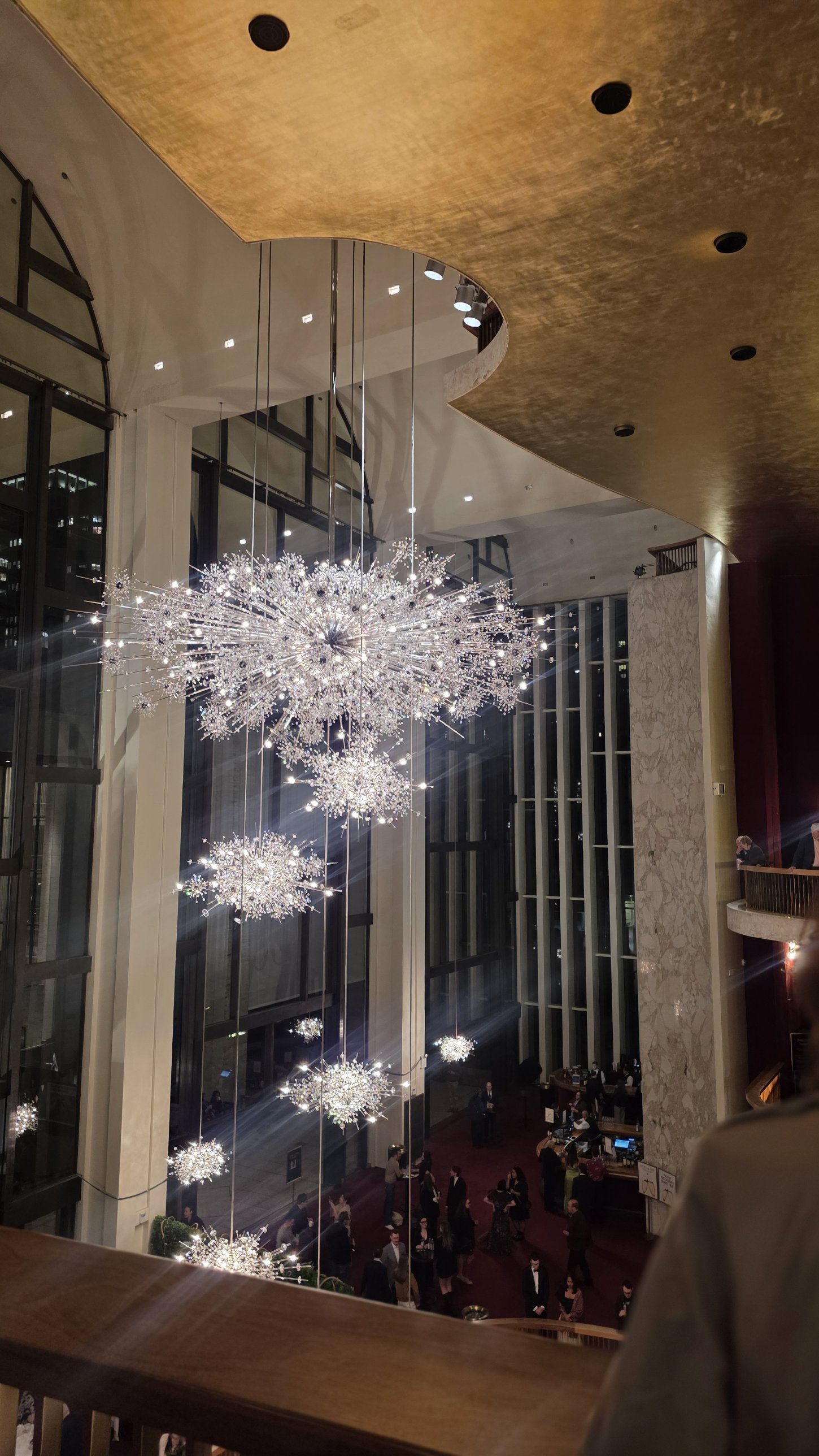 Crystal starburst chandeliers hanging in the Metropolitan Opera House lobby